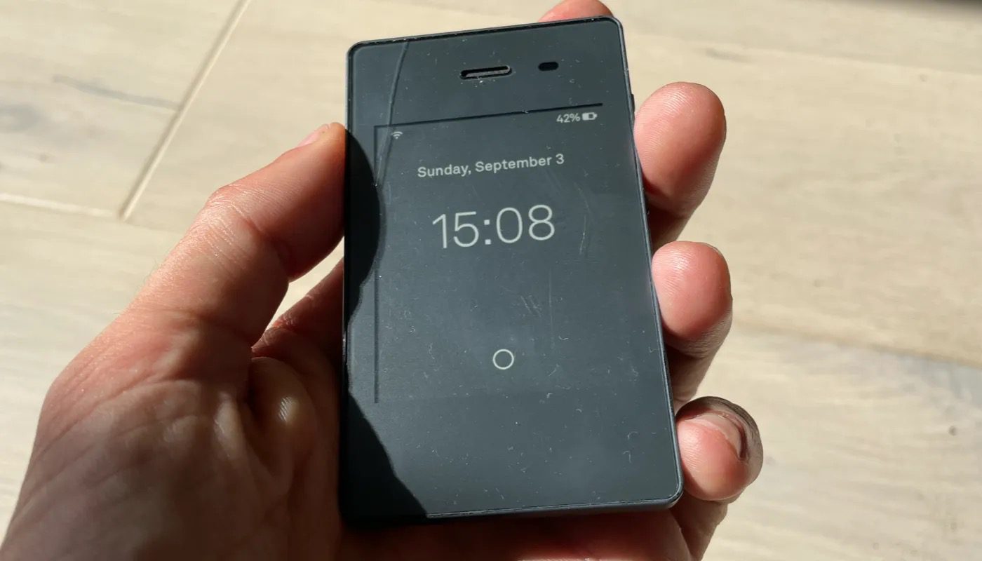 The Light Phone III held in hand showing its minimalist e-ink display
