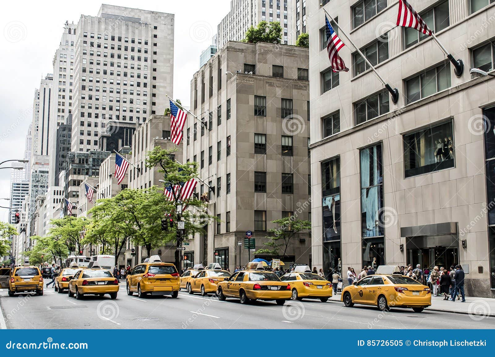 Yellow cab on a Manhattan street with the city skyline behind it